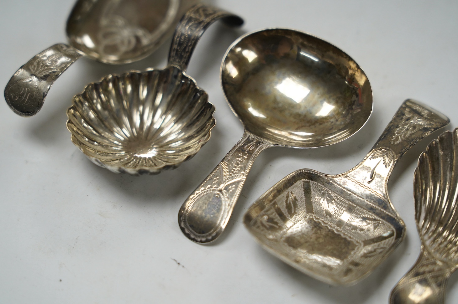 Five assorted silver caddy spoons, including shovel shape by Cocks & Bettridge, Birmingham, 1808, 71mm, oval bowl, John Blake, London, 1804, square bow, Joseph Wilmore, Birmingham, 1810, shell bowl, Joseph Taylor, Birmin